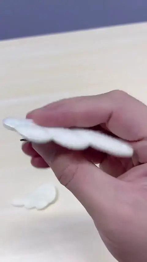 Video demonstrating an angel wing hair clip being opened and closed, transforming from wings to a functional clip.
